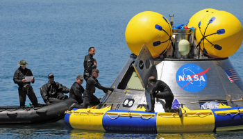 Pararescuemen from the Air Force Reserve’s 920th Rescue Wing performing recovery testing on a mockup of the Orion crew exploration vehicle at the Trident Basin at Port Canaveral, Fla., Mar. 8. credits - U.S. Air Force